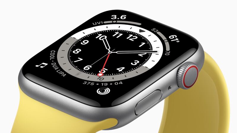 First-generation Apple Watch SE in silver aluminum with a yellow sport band, close-up of the screen
