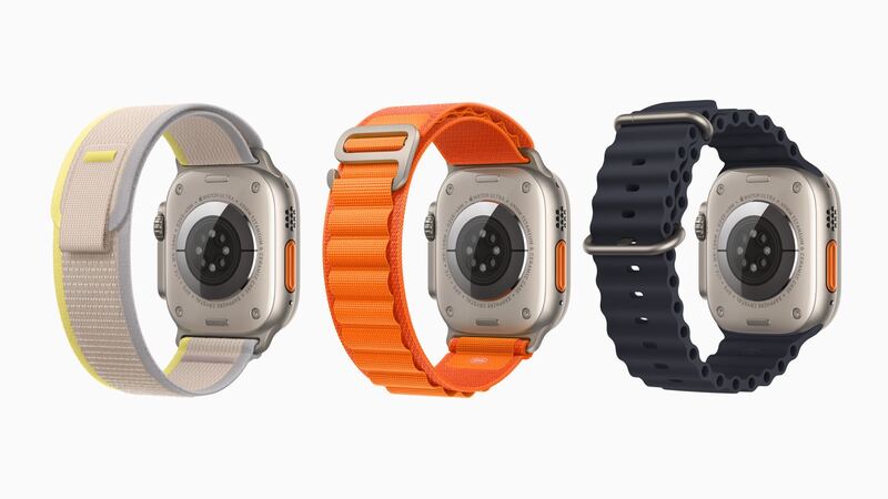 Original Apple Watch Ultra in natural titanium shown from the back with Trail, Alpine and Ocean bands