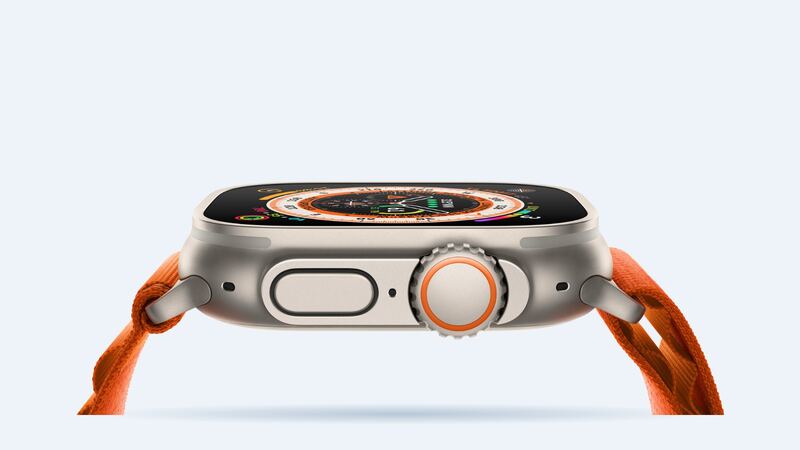 Original Apple Watch Ultra in natural titanium with an orange Alpine Loop, side view of the Digital Crown