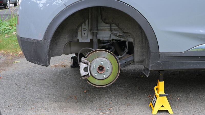 Rear wheel removed showing the disc brake rotor and caliper on a similar Chevrolet