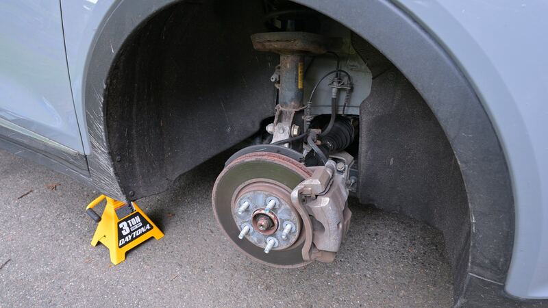 Wheel removed showing the front brake rotor and caliper on a similar Chevrolet car