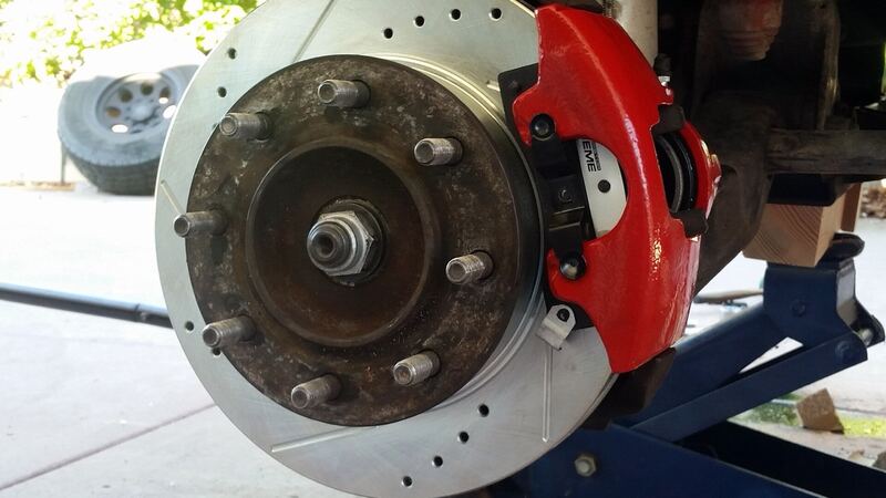 New front brake rotor and caliper on an SUV with the wheel removed