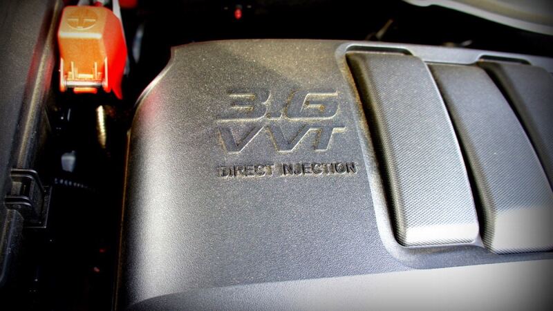 Close-up of the 3.6-liter V6 engine cover in a 2013 GMC Acadia, the Traverse's sibling