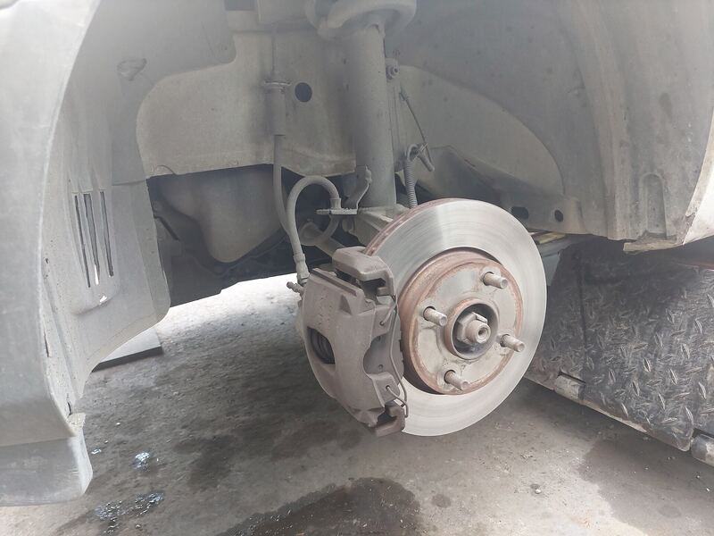 Front disc brake rotor and caliper with the wheel removed on a small crossover (similar vehicle)