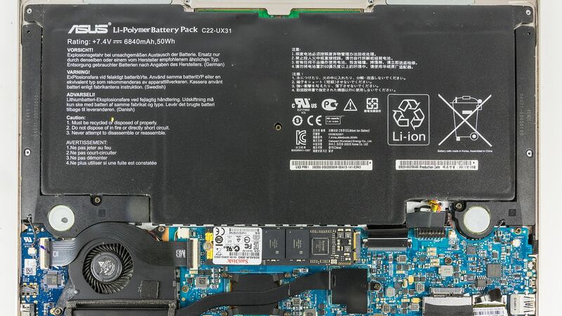 Inside of a thin laptop with the bottom cover off and its large flat battery pack visible (similar laptop, not an XPS 13)