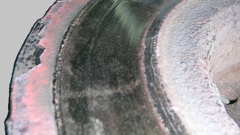 Close-up of a worn, rusty brake disc rotor