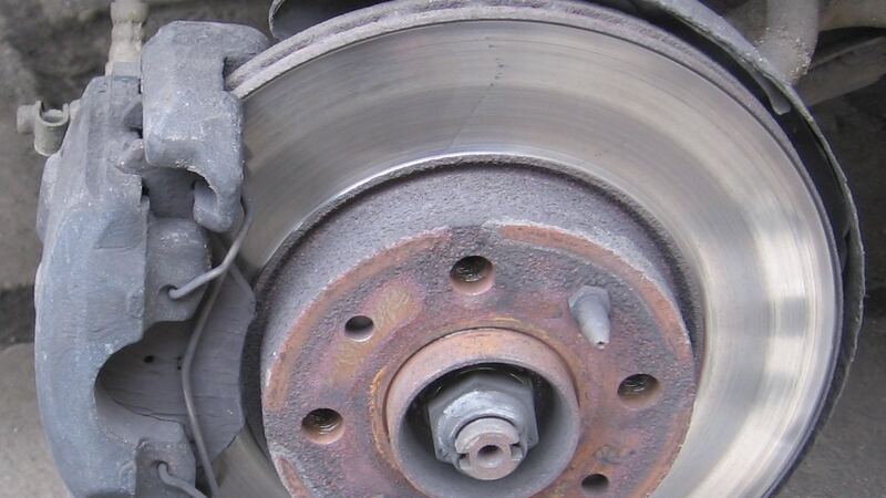 Car disc brake rotor and caliper with the wheel removed, similar vehicle