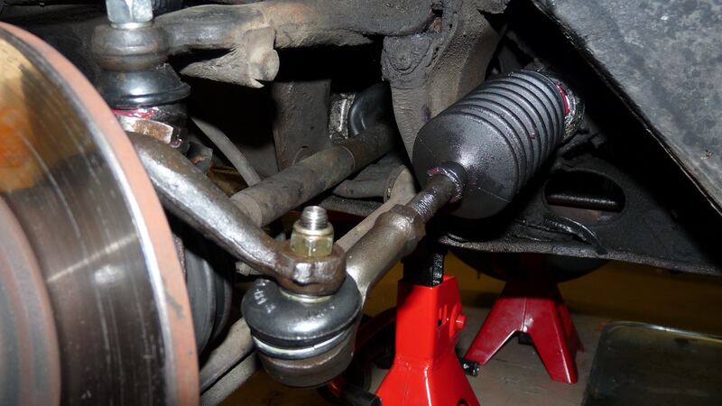 Front brake rotor and steering parts with the wheel off on jack stands (similar vehicle)