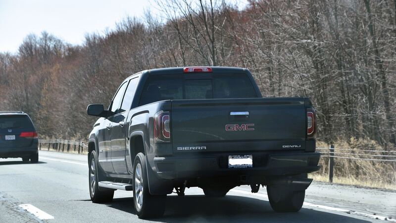Gray 2018 GMC Sierra 1500 Denali seen from the rear on the highway