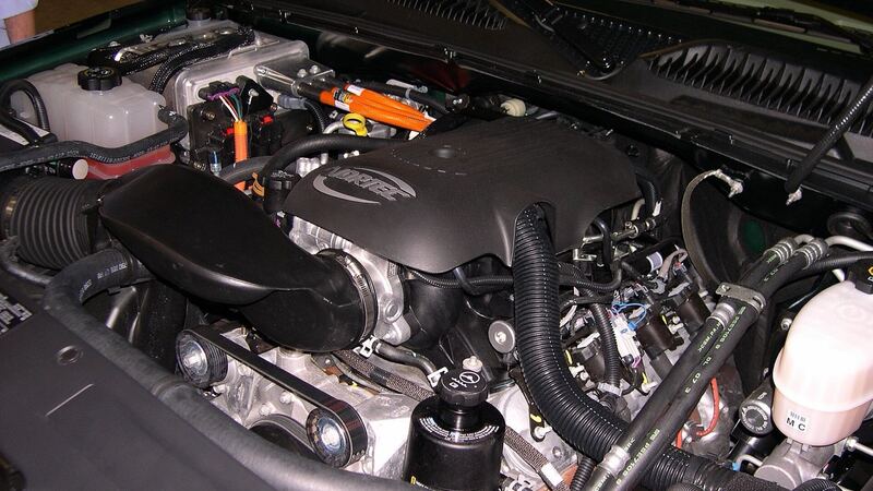 Engine bay of a 2006 GMC Sierra Hybrid with the hood up