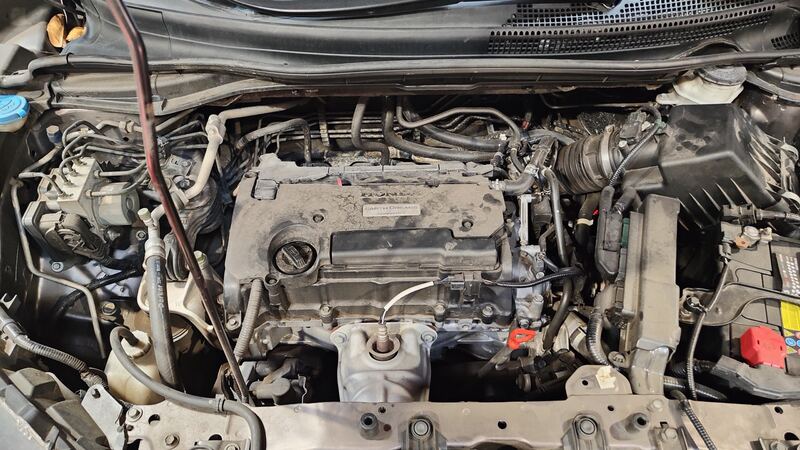 Honda CR-V engine bay with hood up showing AC lines and engine