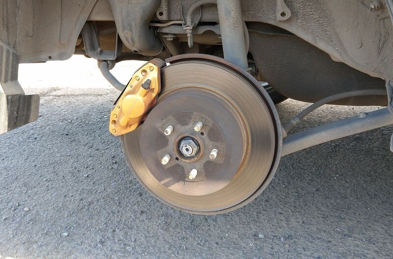 Car with a wheel removed, showing the brake rotor and caliper (similar vehicle)