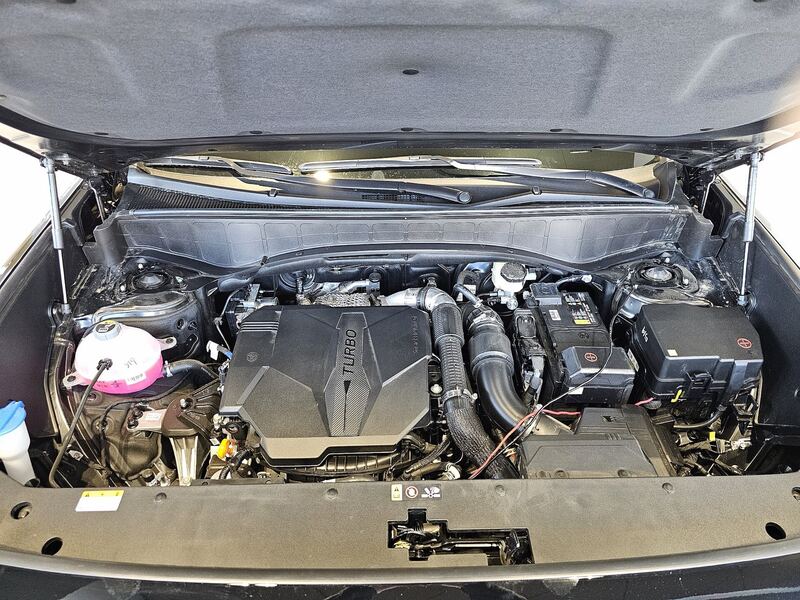 Hood open on a Hyundai Smartstream 2.5 turbo engine bay with the 12V battery at right (similar Hyundai SUV)