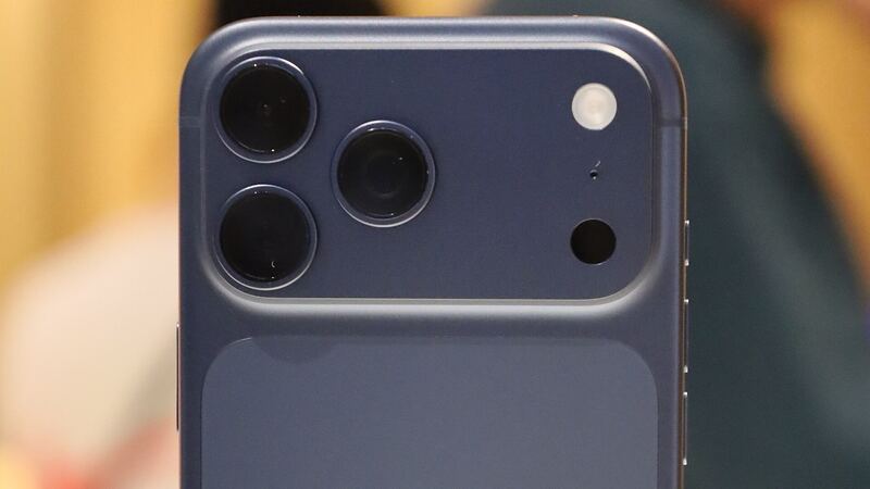 Back of an iPhone 17 Pro Max in deep blue, close-up of the camera plateau