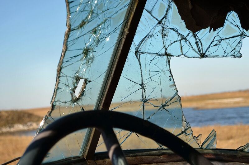 Close-up of a badly cracked windshield on a vehicle