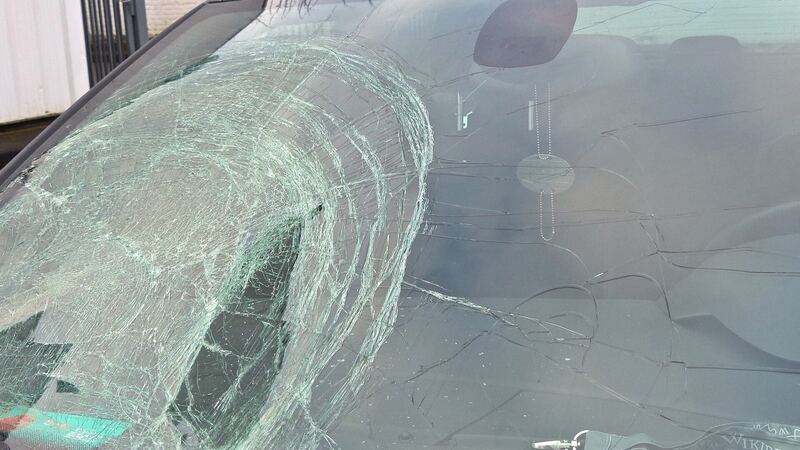 Car windshield badly cracked and splintered after an impact