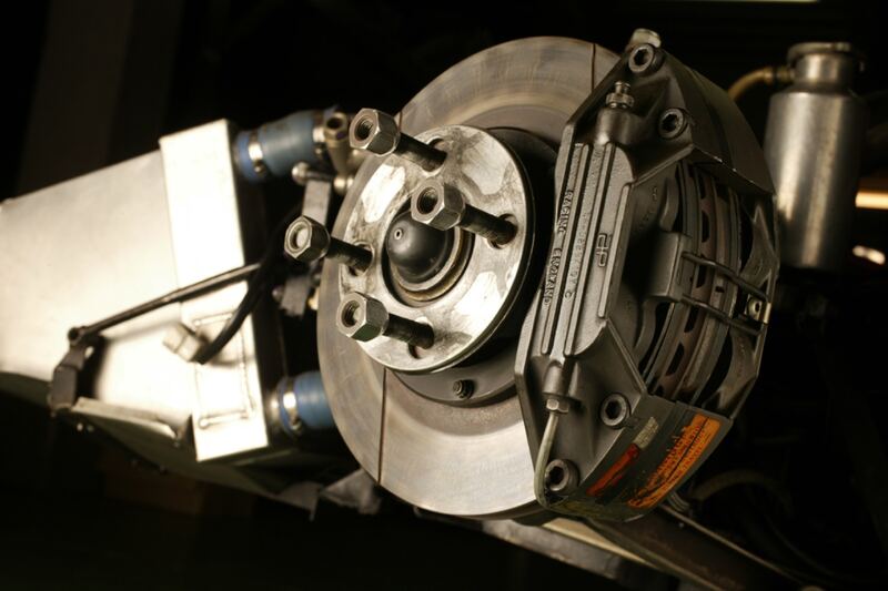 Disc brake rotor, caliper and hub assembly shown on a display stand (similar vehicle)