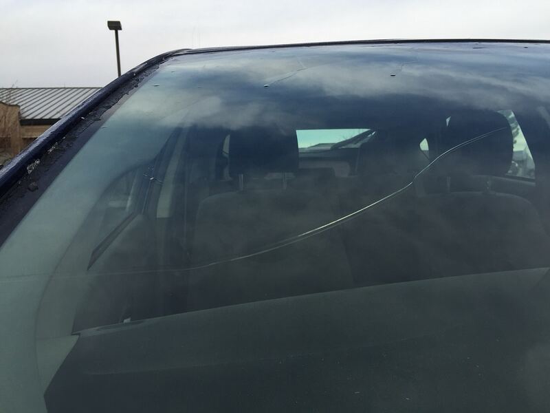 Close-up of a cracked car windshield