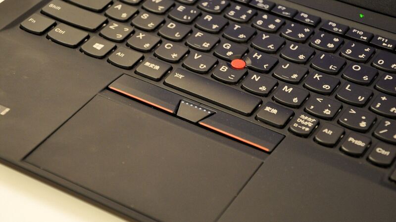 Close-up of a ThinkPad X1 Carbon keyboard with the red TrackPoint and three-button touchpad (older X1 Carbon)