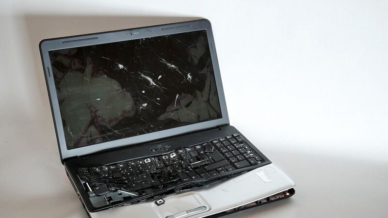 Laptop with a shattered screen and damaged keyboard sitting on a white table (similar laptop, not a Yoga)