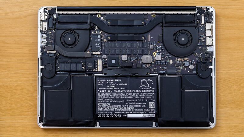 Older MacBook Pro opened up with its battery pack visible (similar model, not the M3)
