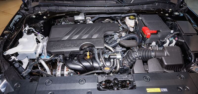 Nissan MR20DD four-cylinder engine bay with the AC lines and compressor area visible