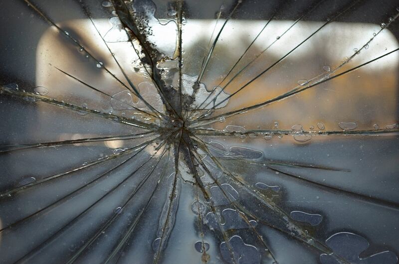Close-up of a windshield with a star-shaped crack spreading across the glass (similar vehicle)