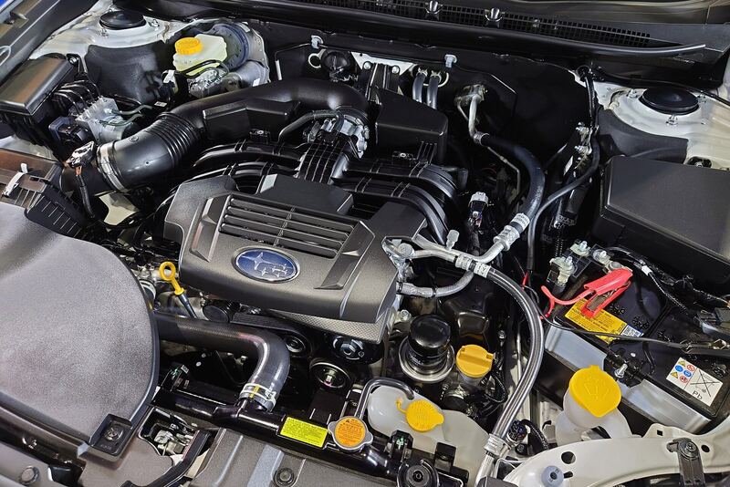 Subaru 2.5-liter boxer engine bay of an earlier Outback with the hood open (similar vehicle)