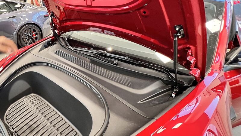 Red 2023 Tesla Model 3 with the front trunk open