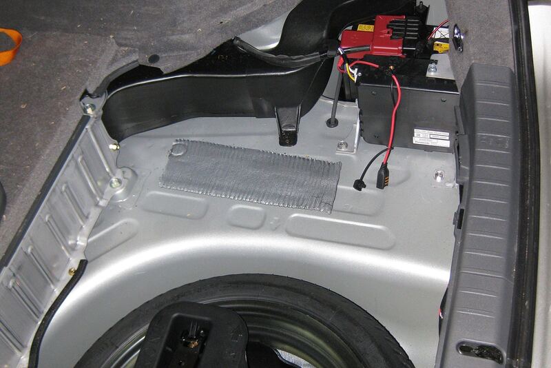 12-volt battery tucked in the trunk side area of a Toyota hybrid (similar vehicle)