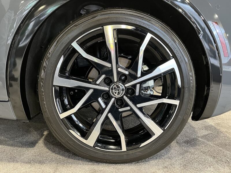 2023 Toyota Prius wheel with the brake rotor and caliper visible behind the spokes
