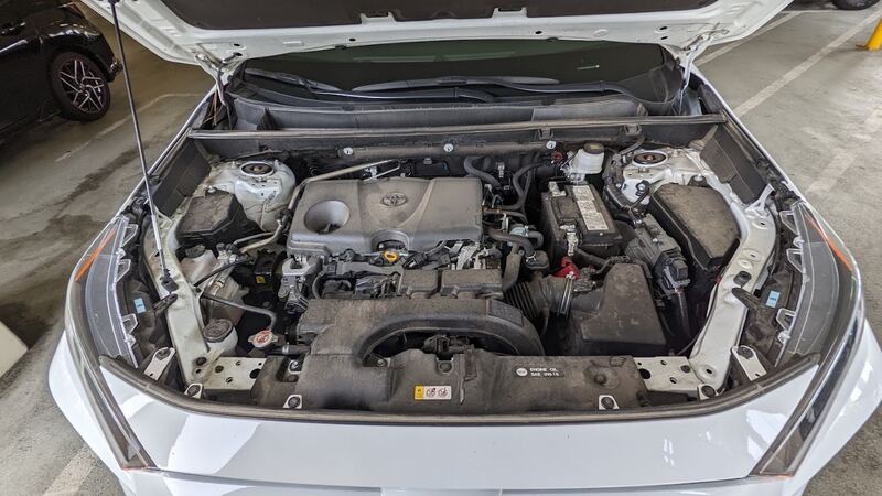 2021 Toyota RAV4 engine bay with the hood open and the 12-volt battery visible