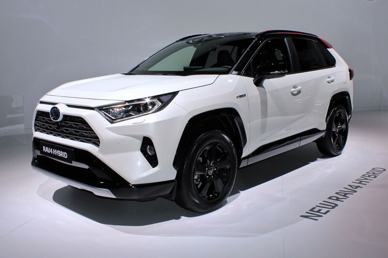 White 2019 Toyota RAV4 Hybrid at an auto show