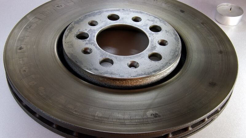 Worn vented brake rotor with heat cracks across the braking surface (similar vehicle)
